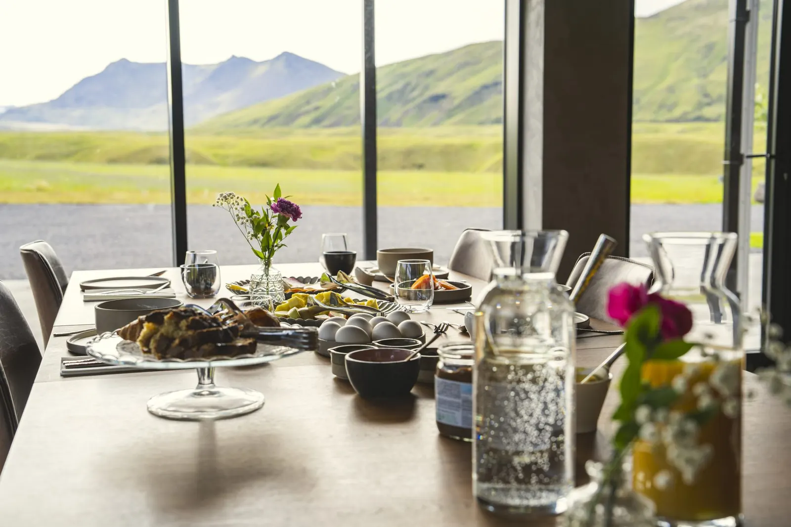 Breakfast table by the window, with the mountains behind