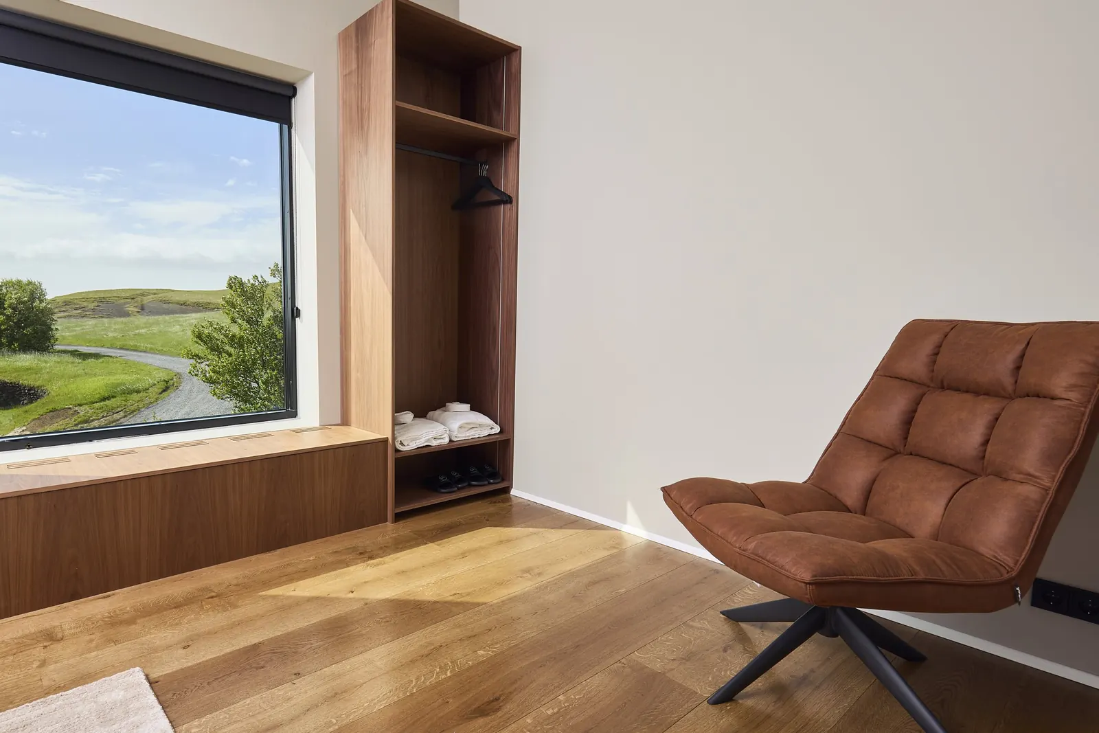 Leather reading chair and window seat in a Deluxe Loft Room